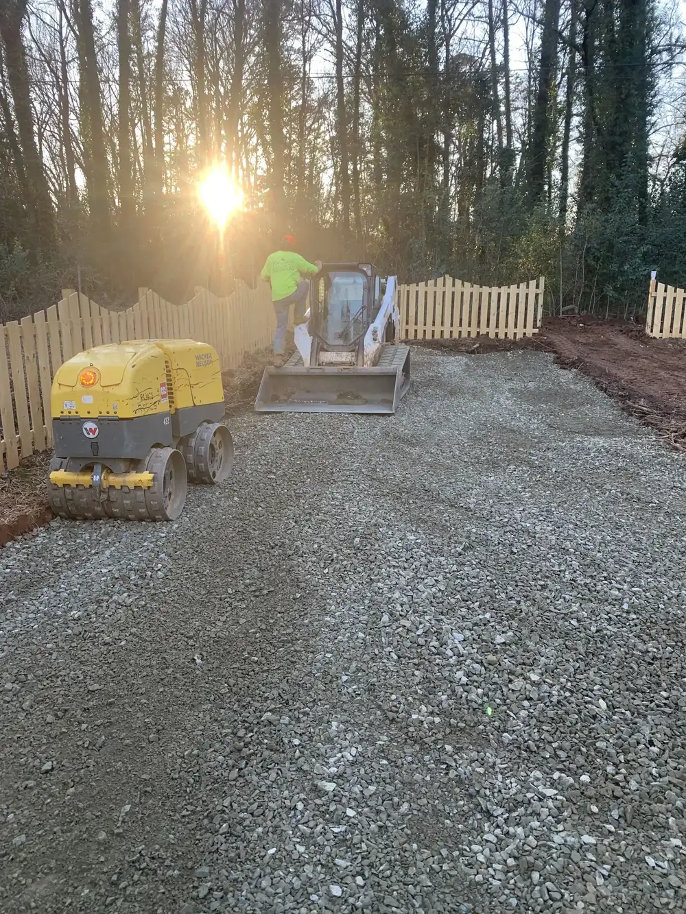 Plate compactor on fresh gravel