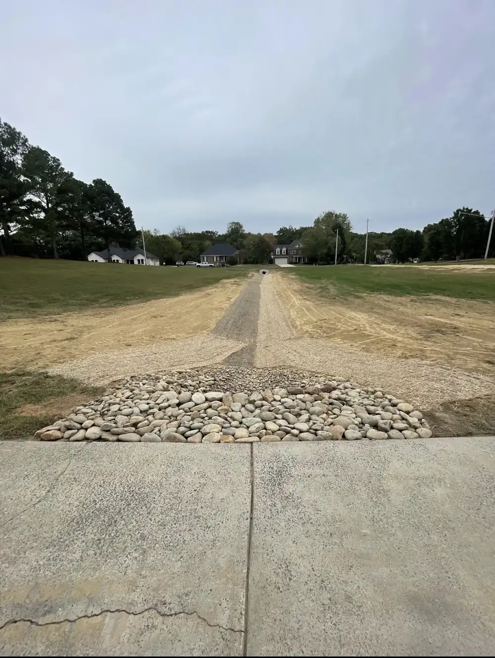 Stone laid where a gravel drive meets the concrete